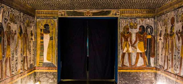 Ancient Egyptian tomb with colorful murals.