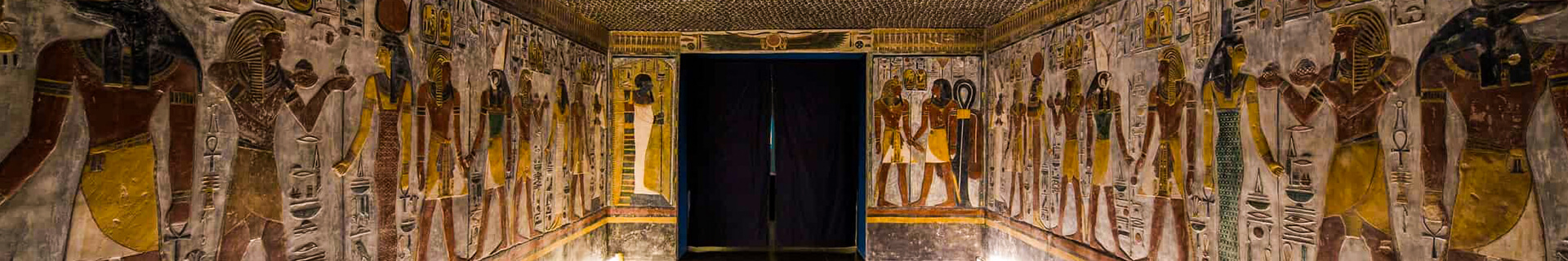 Ancient Egyptian tomb with colorful murals.