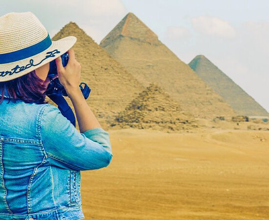 Tourist photographing the Giza Pyramids.