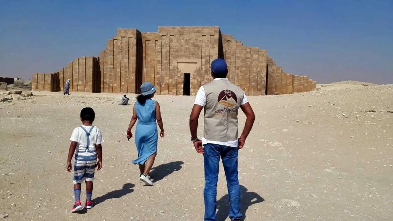 Ramadan in Egypt 2027: What Visitors Should Know - Saqqara - Three visitors walking toward ancient stone pyramid structure in desert